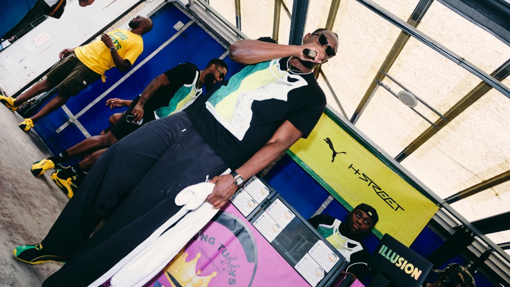 Usain Bolt holds microphone at Notting Hill Carnival Stage