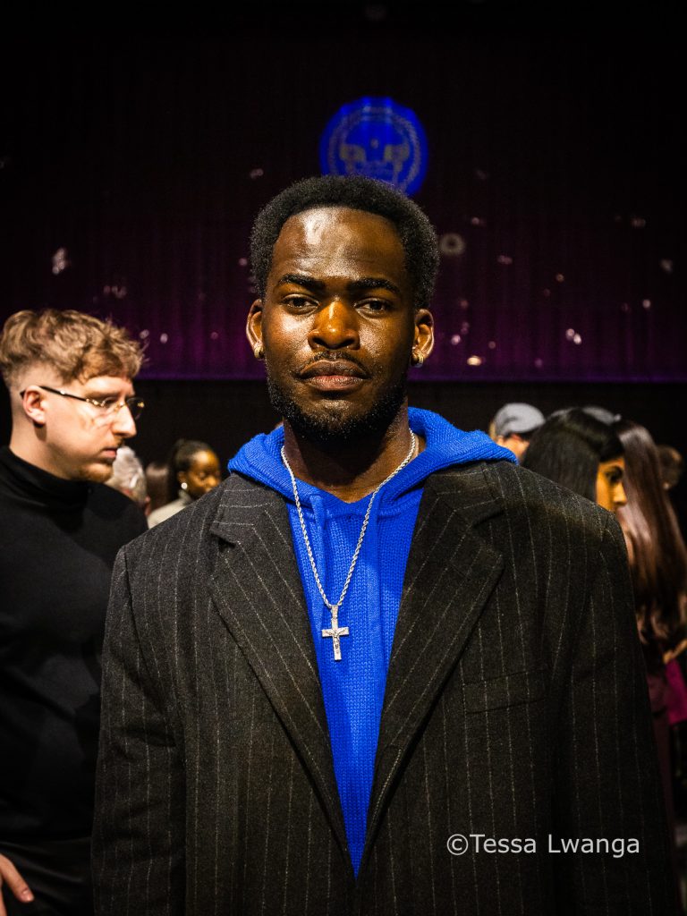 LFWAW25-1238 Victor Olusina at Fashion Show, wearing blue hoodie.